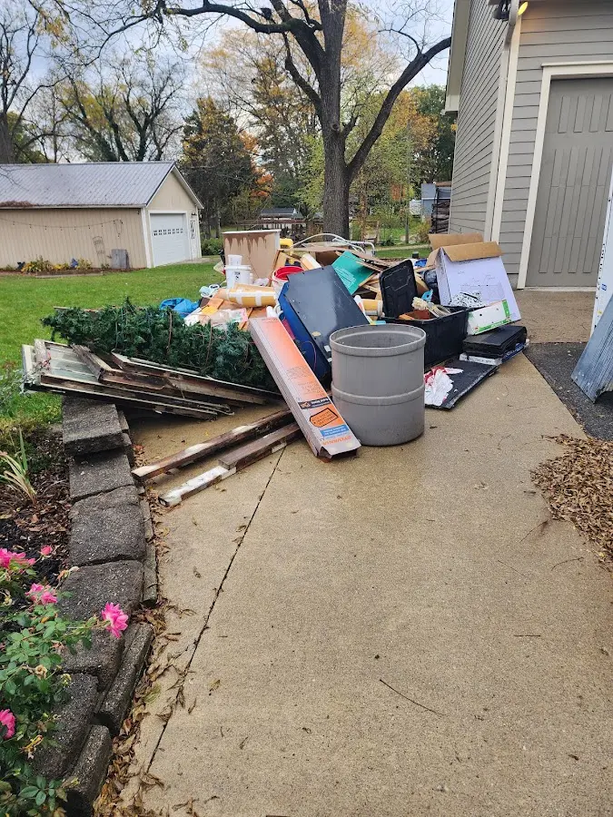 Dumpster being loaded with debris for Roofing Dumpster Rental in Buies Creek